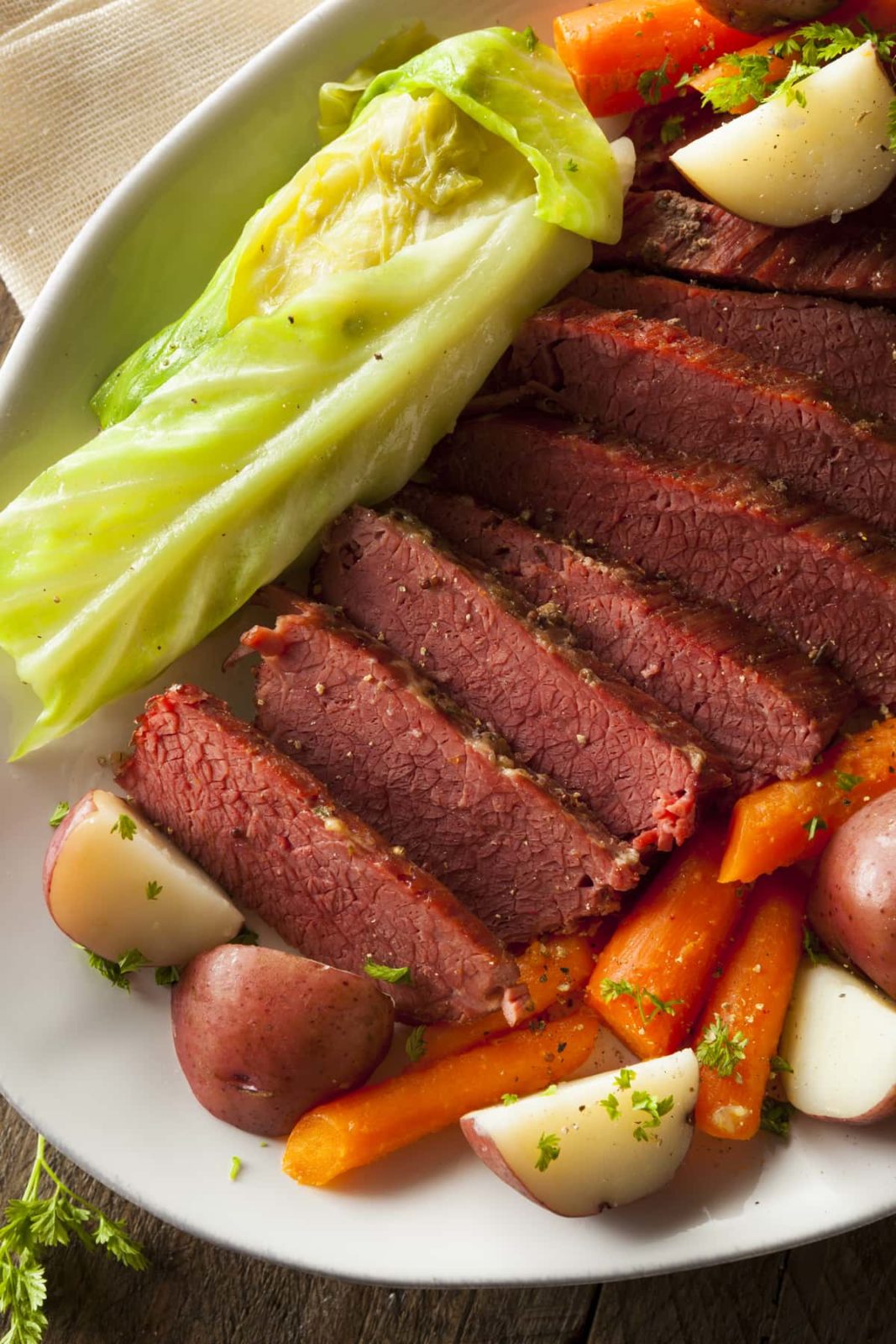 Sliced corned beef and cabbage on a white plate