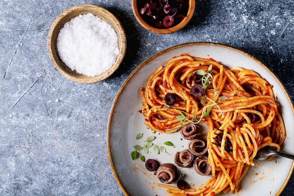 Plate of Linguine with sliced kalamata olives and anchovies